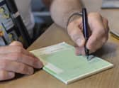 Dr Laurence Buckman writes a prescription in his practice room at the Temple Fortune Health Centre GP Practice near Golders Green, London.