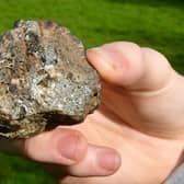 Christopher Patching, of Stickney, holding what he believes is a meteorite that he saw fall from the sky over Stickney.