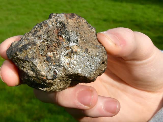 Christopher Patching, of Stickney, holding what he believes is a meteorite that he saw fall from the sky over Stickney.