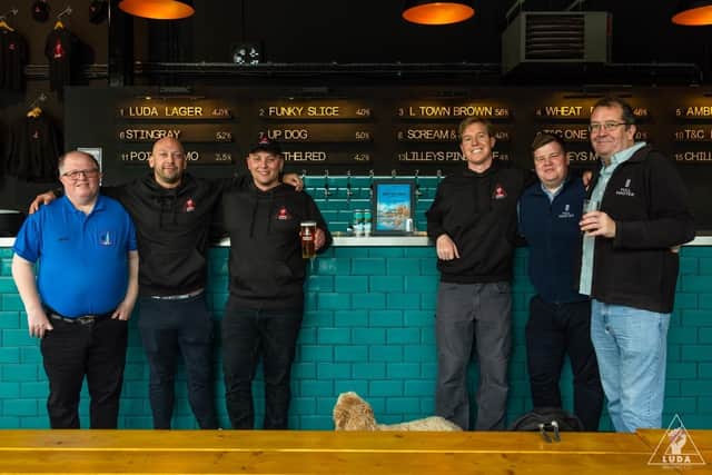 Jack, Kieran and Joe Byrd from Luda (centre) receiving the award from the Hull Minster Beer Festival team.