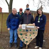 Library manager Kay Turnbull with some of the Old Station Group members and the wooden heart