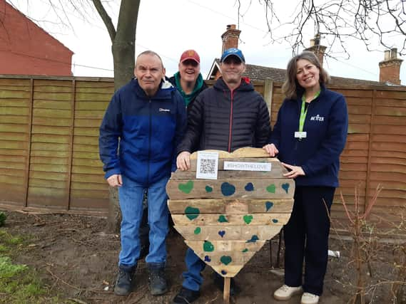 Library manager Kay Turnbull with some of the Old Station Group members and the wooden heart