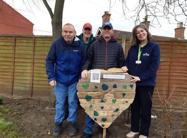 Library manager Kay Turnbull with some of the Old Station Group members and the wooden heart