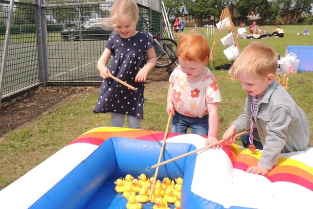 Joining in the jubilee sports afternoon at Cranwell playing field, from left Darcy Standeven, aged three, Evie Ward, two and Tommy Ward, four, playing hook a duck.