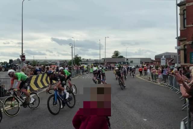 A still from the footage as the woman crossed the road as the cyclists spped past.