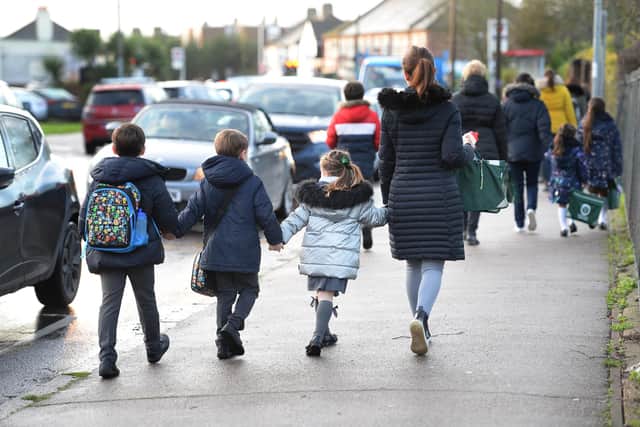 Parents walk their children to school in Hornchurch, Essex, past stationary vehicles near to the school grounds. PA Photo. Picture date: Friday January 17, 2020. Photo credit should read: Nick Ansell/PA Wire