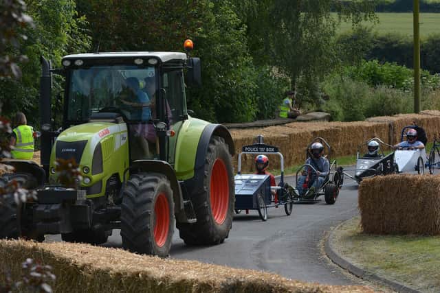 Soapbox racers are hauled back up the hill for another run in the Coleby Downhill Challenge. Photo: Kartpix