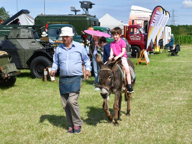 Tomas Goddard-Richardson 6 of Greylees, riding a donkey lead by Cliff Collins of Cobwebs Donkeys.