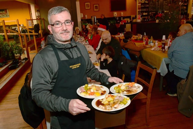 Volunteer, Martin McKechnie serving meals.