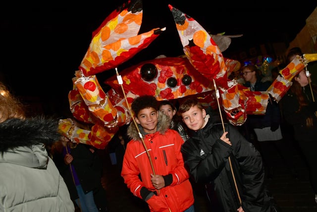 Two young members of the Illuminate parade with a hand-made crab.