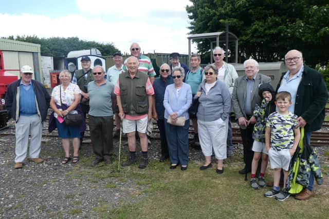 Skegness Probus Club in the LCLR's yard with Peter Balderstone, against a background of locomotives 'Sark', "Paul' and 'Wilton'.