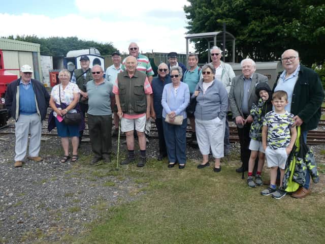 Skegness Probus Club in the LCLR's yard with Peter Balderstone, against a background of locomotives 'Sark', "Paul' and 'Wilton'.