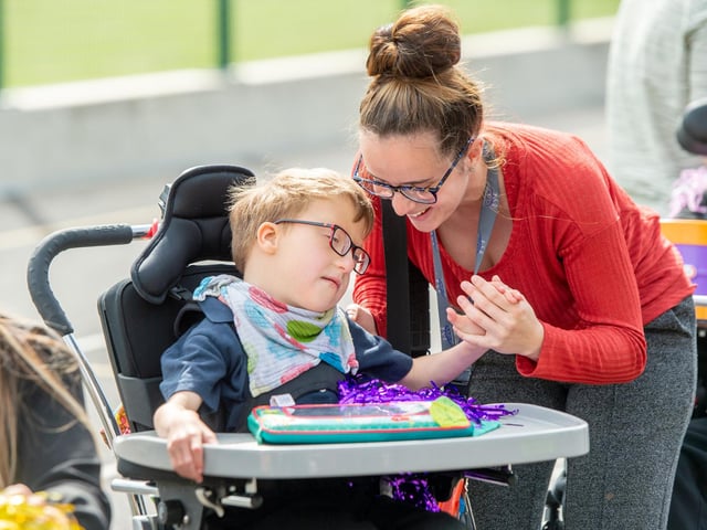 A staff member with one of the pupils at the official opening of the new school.
