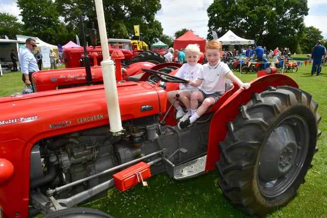 Enjoying a sit on this vintage tractor is Reggie Jeffery, left, and Bobby Britton, both aged four, of Boston.
