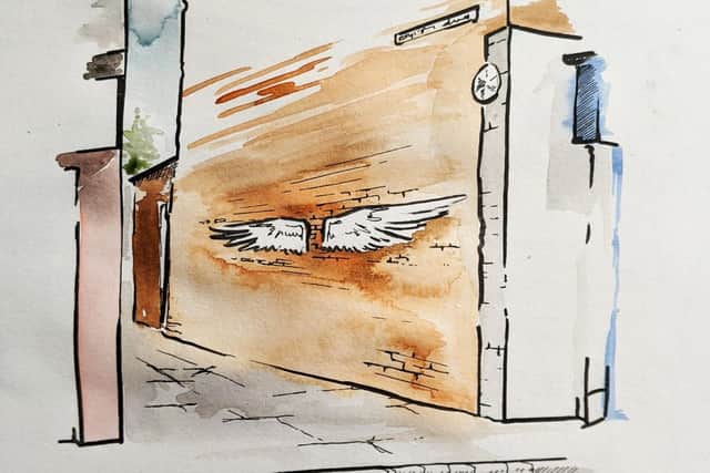 An impression of the scale of a wings art installation on a passageway wall in Boston.