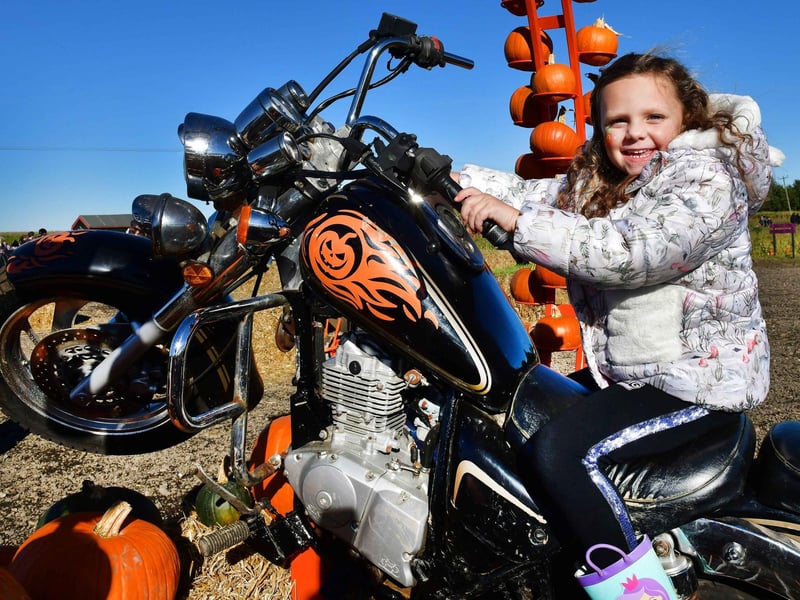 Young Mya has a go on the motorbike photo station.