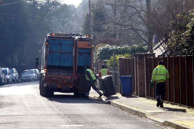 Council workers empty bins in Sunningdale, Berkshire .