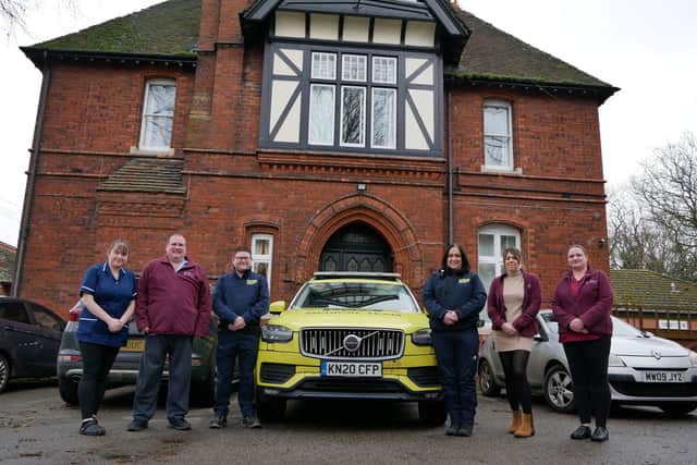 4 staff from the team at Bernadette House, and two of LIVES’ CEMS team with a LIVES Medical Response car.