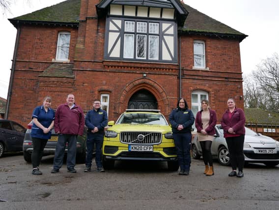 4 staff from the team at Bernadette House, and two of LIVES’ CEMS team with a LIVES Medical Response car.