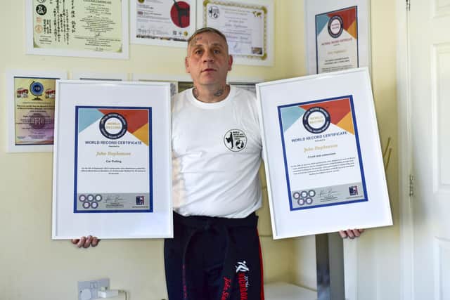 Holding up some of his Official Record Breakers certificates, John Stephenson, of Donington.