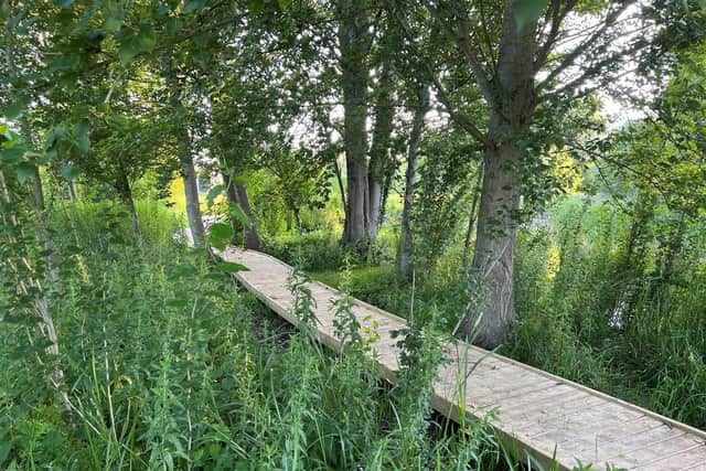 The boardwalk around the pond at Lollycocks Field. Young people are warned to keep off the pond in icy weather.