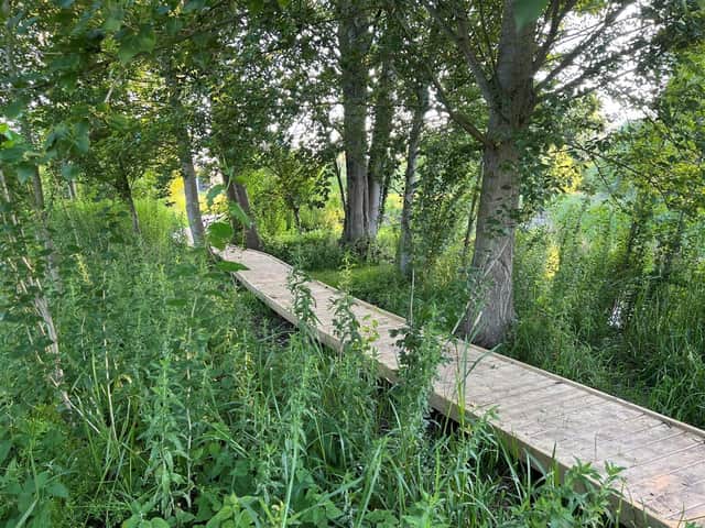 The boardwalk around the pond at Lollycocks Field. Young people are warned to keep off the pond in icy weather.