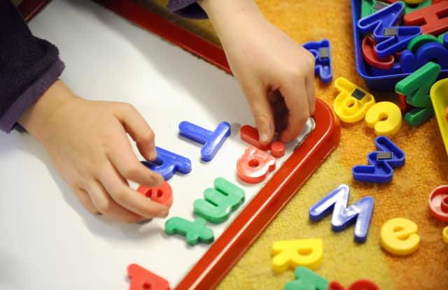 File photo dated 08/02/12 of a child playing. Plans to expand the number of subsidised childcare places for working parents in England 'should not come at the expense of quality', a MPs report says.