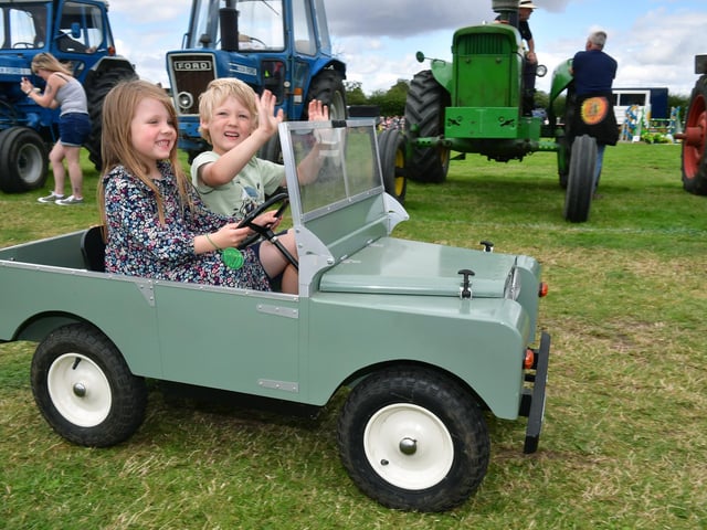 Youngsters enjoying a ride in a miniature Land Rover at Heckington Show.