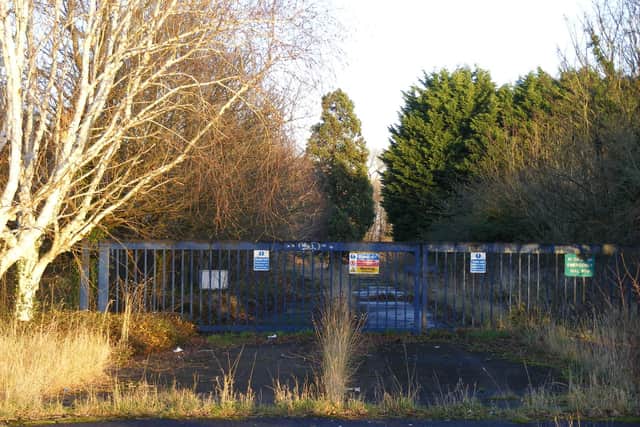 The overgrown entrance to the former Advanta site. (File photo)