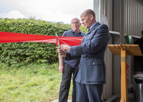 Group Captain Lewis Cunningham, officer commanding RAF Coningsby, opening the Dakota hangar. Photo: Holly Parkinson