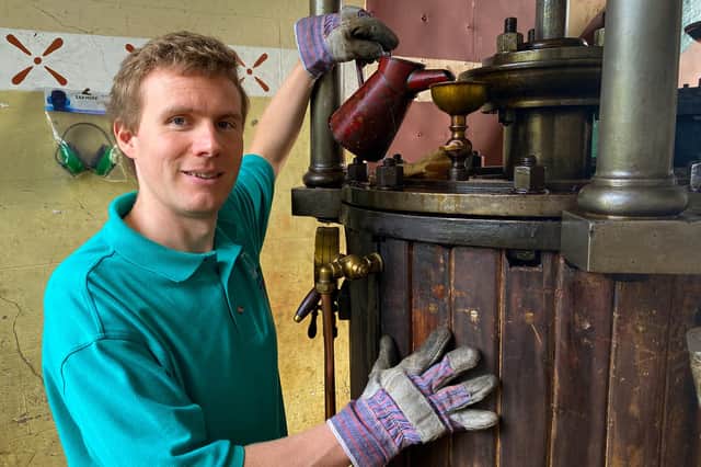 Volunteer Richard Knight oils the beam engine.