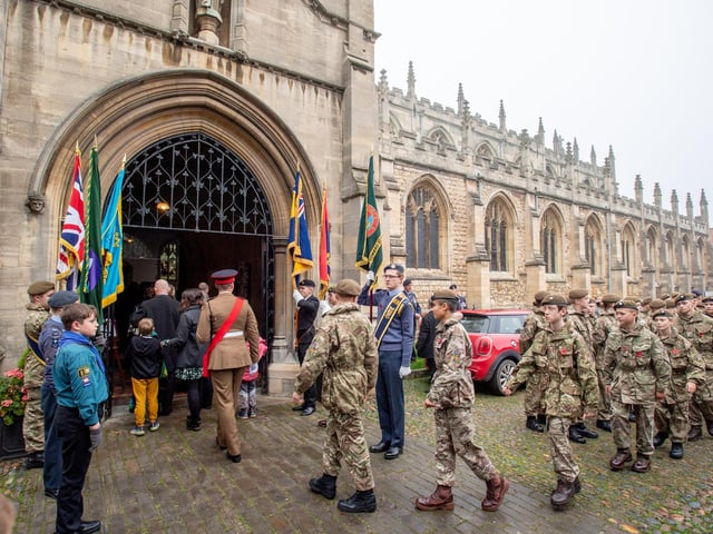 The parade heads into St James Church.