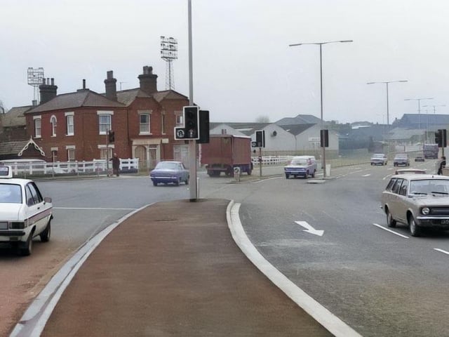 On the edge of the frame, a 'jam sandwich' style police car.