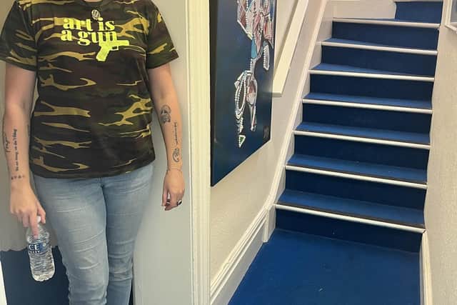 Dale on the stairs near the kitchen where voices have been heard and a picture on the wall has rotated.