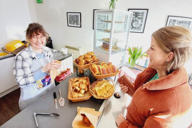 A delighted Yulia is all smiles as she welcomes one of her first customers to the new bakery. Image: Dianne Tuckett