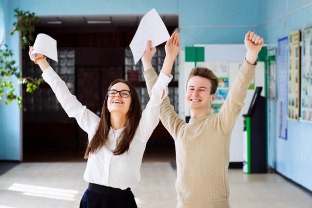 Students celebrate as they receive their A Level results