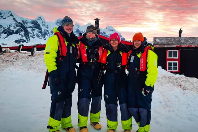 Clare (left) and the team wrapped up warm in float suits at Port Lockroy. Photo: Lucy Bruzzone/UKAHT