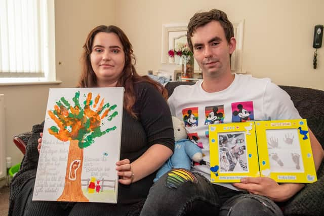 Andrea and Brad with the keepsakes they made of baby Noah.