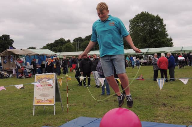 Rowan Ley, skipping while balancing on a ball in the circus skills area at Metheringham's jubilee carnival.