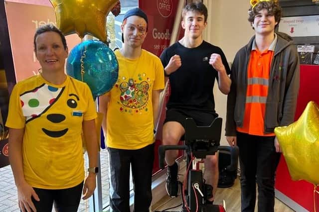 Pedalling for Pudsey - from left - Kerri Foster from Barclays, Lee Taylor, Will Chenary on the bike and Kyle McDonald at Sleaford Post Office. Photo supplied