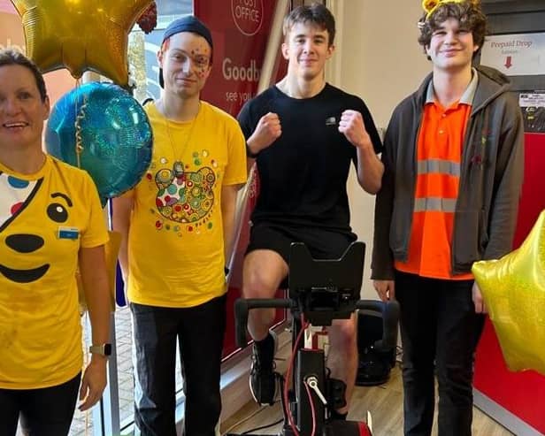 Pedalling for Pudsey - from left - Kerri Foster from Barclays, Lee Taylor, Will Chenary on the bike and Kyle McDonald at Sleaford Post Office. Photo supplied