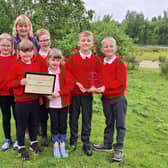 Sue Feary with students from the eco committee and the 2024 trophy