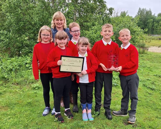 Sue Feary with students from the eco committee and the 2024 trophy