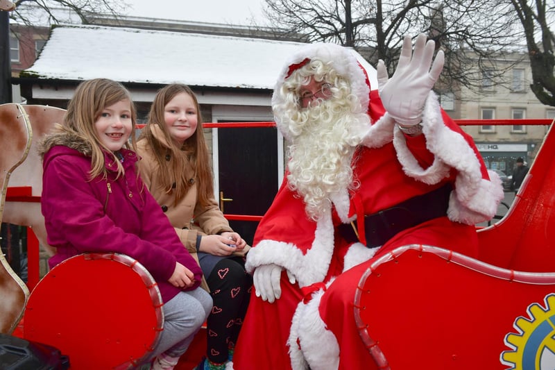 L-R Izzy Metcalf 8 and Penny Metcalf 10 of Ruskington with Father Christmas at The Rotary Club of Sleaford and Kesteven stall.