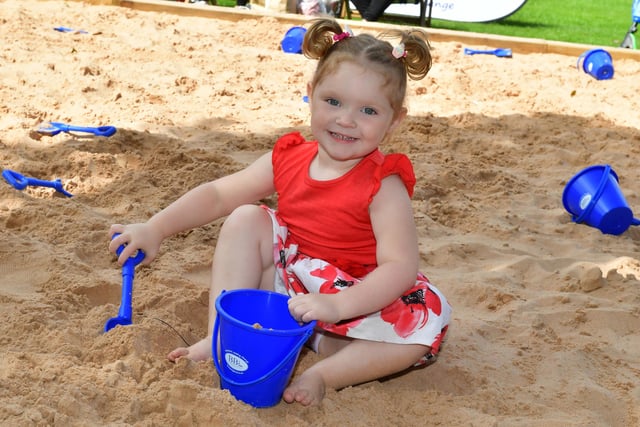 Layla-May Lewis, two, of Boston, enjoying some sand play.