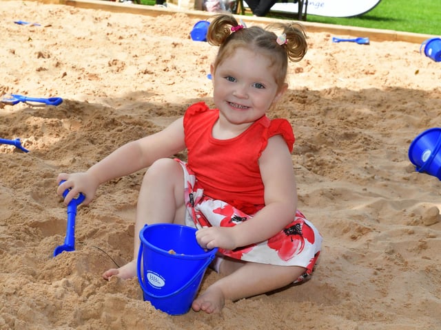 Layla-May Lewis, two, of Boston, enjoying some sand play.