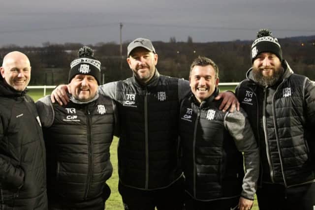 Brigg Town’s coaching staff, including Dave Smith (centre) celebrate a win back in December. Photo: Brigg Town FC.