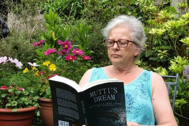 Flo Moore reading one of the books