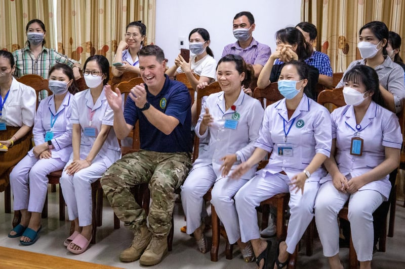 Royal Navy Capt. Joesph Dransfield, Pacific Partnership 2023 deputy mission commander, and Phu Yen General Hospital nurses watch medical demonstrations during Pacific Partnership 2023. (U.S. Navy photo by Chief Mass Communication Specialist Eric Chan)