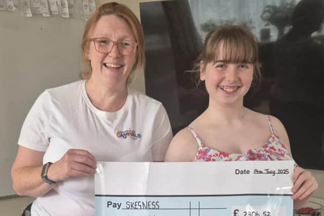 Former Skegness Carnival Queen Summer Willets, 15, presents a cheque to event organiser Caroline Miller.